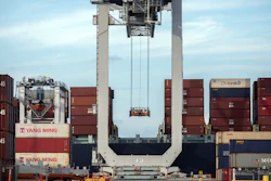 In this July, 5, 2018, file photo, a ship to shore crane prepares to load a 40-foot shipping container onto a container ship in Savannah, Ga.