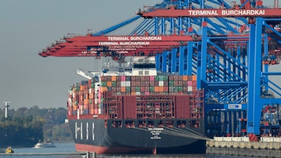 In this Oct. 15, 2018, file photo, a container ship is loaded at the harbor in Hamburg, Germany.