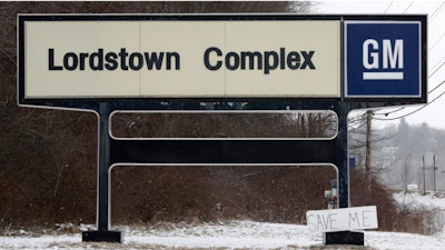 In this March 6, 2019, file photo, a 'Save Me' sign rests against the General Motors Lordstown Complex sign in Lordstown, Ohio.