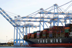 In this Nov. 4, 2019, file photo, cargo cranes take containers off of a Yang Ming Marine Transport Corp. boat at the Port of Tacoma.