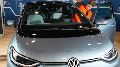 CDU party chairwoman Annegret Kramp-Karrenbauer takes a seat in an electric ID.3 car displayed by Volkswagen at the CDU convention in Leipzig, Nov. 23, 2019.