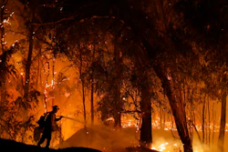 In this Oct. 31, 2019, file photo, a firefighter battles a wildfire in Somis, Calif.