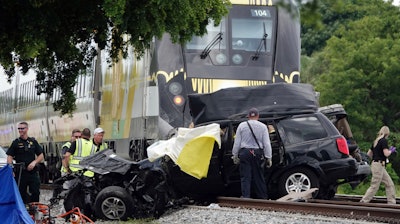 In this Aug 25, 2019, file photo, Broward Sheriff's Deputies and Pompano Beach Fire Rescue work the scene of a fatal accident on North Dixie Highway in Pompano Beach, Fla.