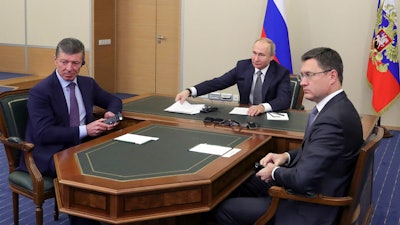 Russian President Vladimir Putin, center, Deputy Prime Minister Dmitry Kozak, left, and Energy Minister Alexander Novak attend a joint video conference with Chinese President Xi Jinping in the Bocharov Ruchei residence, Sochi, Russia, Dec. 2, 2019.