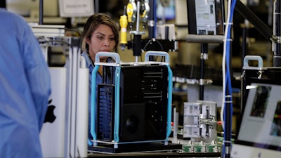 In this Nov. 20, 2019, file photo, workers assemble Apple products in Austin, Texas.