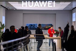 In this Nov. 20, 2019, photo, customers shop at a Huawei store in Beijing.