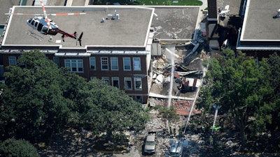 In this Aug. 2, 2017, file photo, emergency workers respond to an explosion at Minnehaha Academy in Minneapolis.