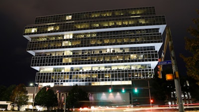 In this Sept. 12, 2019, file photo, cars pass Purdue Pharma headquarters in Stamford, Conn.