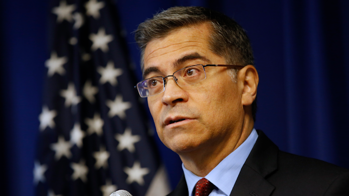 California Attorney General Xavier Becerra discusses settlements reached with 52 automobile parts manufacturers for illegal bid rigging during a news conference, Dec. 4, 2019, in Sacramento.