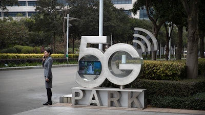 A Huawei employee talks on her cellphone at Huawei's campus in Shenzhen, Dec. 5, 2019.