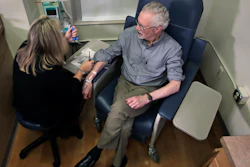 Charles Flagg, who is stricken with Alzheimer's disease, sits for an infusion while participating in a study on the drug Aducanumab at Butler Hospital in Providence, R.I.