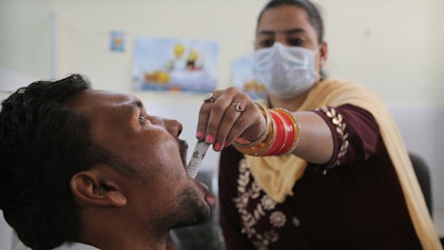 In this Oct. 31, 2019, photo, a medic administers medicine to a recovering drug addict at a de-addiction center in Kapurthala, Punjab, India.