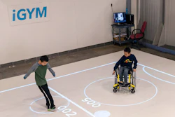 In this Nov. 17, 2019, photo, brothers Darren Kreps, left, and Bryan Kreps play a game modeled after soccer and air hockey in Ann Arbor, Mich.
