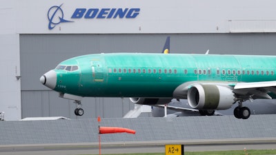 In this April 10, 2019, file photo, a Boeing 737 Max 8 lands at Boeing Field in Seattle.
