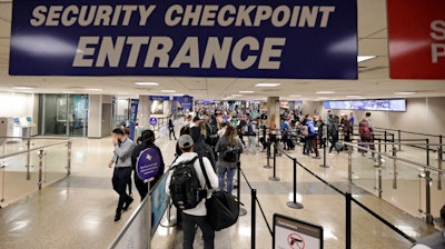 In this Nov. 27, 2019, file photo, travelers walk through a security checkpoint in Terminal 2 at Salt Lake City International Airport.