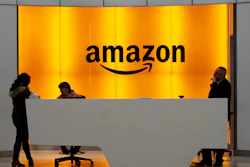 In this Feb. 14, 2019, file photo, people stand in the lobby of Amazon's offices in New York.