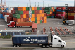 In this Oct. 2, 2019, file photo, trucks haul shipping containers at a terminal on Harbor Island in Seattle.