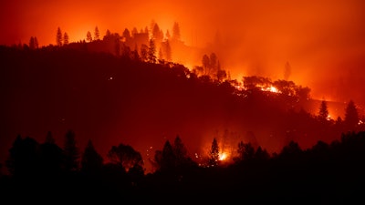 In this Nov. 10, 2018, file photo, the Camp Fire burns along a ridgetop near Big Bend, Calif.