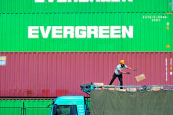 In this Oct. 14, 2019, file photo, a worker loads imported goods on a truck at a distribution company outside the container port in Qingdao, Shandong province.