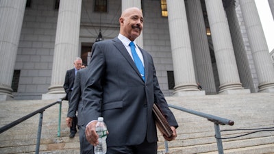 In this Oct. 22, 2019, file photo, Ted Wells, Jr., the lead attorney for Exxon, leaves New York Supreme Court in New York.