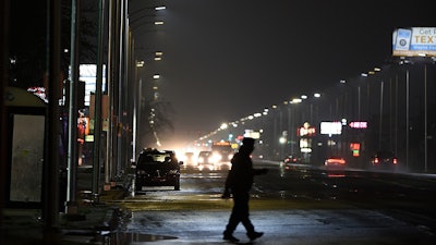 In this May 2, 2019, file photo, a pedestrian crosses Gratiot Street at Outer Drive East in Detroit.