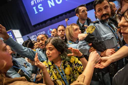 Demonstrators scuffle with UN security staff members during a protest at the COP25 summit in Madrid, Dec. 11, 2019.