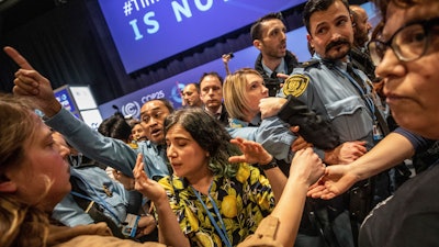 Demonstrators scuffle with UN security staff members during a protest at the COP25 summit in Madrid, Dec. 11, 2019.