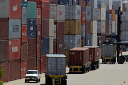 In this July 22, 2019, file, stacked containers wait to be loaded on to trucks at the Port of Oakland in Oakland, Calif.