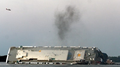 In a Sept. 8, 2019, file photo, smoke rises from a cargo ship that capsized in the St. Simons Island, Georgia sound.