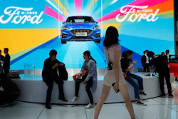 In this April 25, 2018, file photo, attendees visit the Ford booth during Auto China 2018 in Beijing.