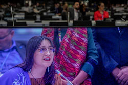 A member of IFAD farmer is seen on the screen during a closing speed at the COP25 closing plenary in Madrid, Dec. 15, 2019.