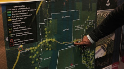 In this March 18, 2019, file photo, Rogelio Jiménez Pons, director of Fonatur, points to a map of a planned train line through the Yucatan Peninsula.