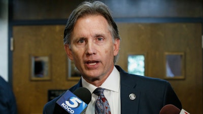 In this Oct. 15, 2019, file photo, Oklahoma Attorney General Mike Hunter talks with reporters following a hearing to settle disagreements between Johnson & Johnson and the state.