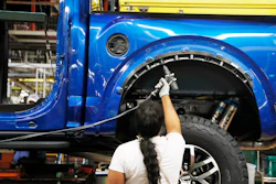In this Sept. 27, 2018, file photo, an assemblyman works on a 2018 Ford F-150 truck at the Ford Rouge plant in Dearborn, Mich.