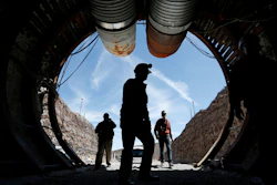 In this April 9, 2015, file photo, people walk into the south portal of Yucca Mountain during a congressional tour of the proposed radioactive waste dump near Mercury, Nev.