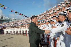 In this photo provided by China's Xinhua News Agency, Chinese President Xi Jinping meets with representatives of the aircraft carrier unit and the manufacturer at a naval port in Sanya, Dec. 17, 2019.