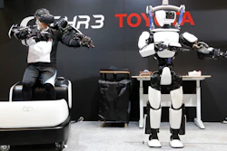 In this Dec. 18, 2019, photo, Toyota's human-shaped T-HR3 robot is remotely controlled by its staff member during a demonstration in Tokyo.