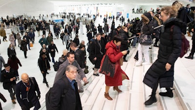 In this Dec. 4, 2019, file photo, commuters pass through the World Trade Center in New York.