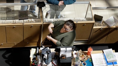 In this April 9, 2018, file photo, a cashier rings up a purchase at a store in Salem, N.H.