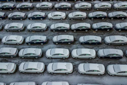 In this Dec. 5, 2018 file photo, hundreds of Chevrolet Cruze cars sit in a parking lot at General Motors' assembly plant in Lordstown, Ohio.