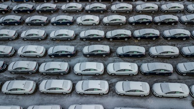 In this Dec. 5, 2018 file photo, hundreds of Chevrolet Cruze cars sit in a parking lot at General Motors' assembly plant in Lordstown, Ohio.