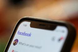 In this Aug. 11, 2019, file photo, an iPhone displays a Facebook page in New Orleans.