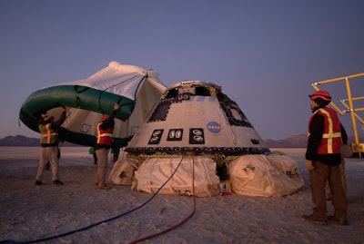 Boeing, NASA and U.S. Army personnel work around the Boeing Starliner spacecraft shortly after it landed in White Sands, N.M., Dec. 22, 2019.