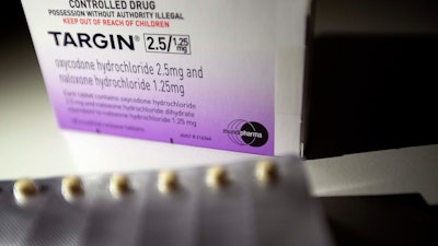 In this July 17, 2019, file photo, a pack of Targin opioid pills made by Mundipharma is photographed in Sydney.