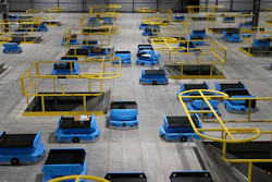 In this Dec. 17, 2019, photo, dozens of robots transport packages at an Amazon warehouse facility in Goodyear, Ariz.