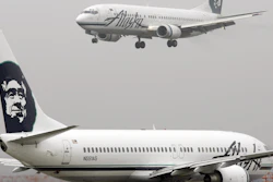 An Alaska Airlines plane comes in for a landing as another taxis for takeoff at Seattle-Tacoma International Airport, Jan. 16, 2009.