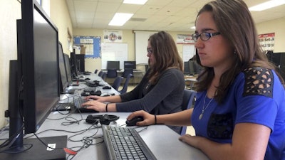 Students Leticia Fonseca (left) and her twin sister, Sylvia Fonseca, at Cuyama Valley High School in New Cuyama, Calif., May 2015.