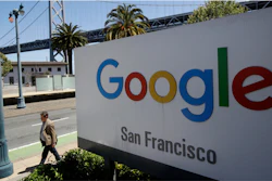 In this May 1, 2019, file photo, a man walks past a Google sign in San Francisco.