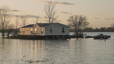 In this Oct. 22, 2019 photo, a home is surrounded by floodwaters in Bartlett, Iowa.