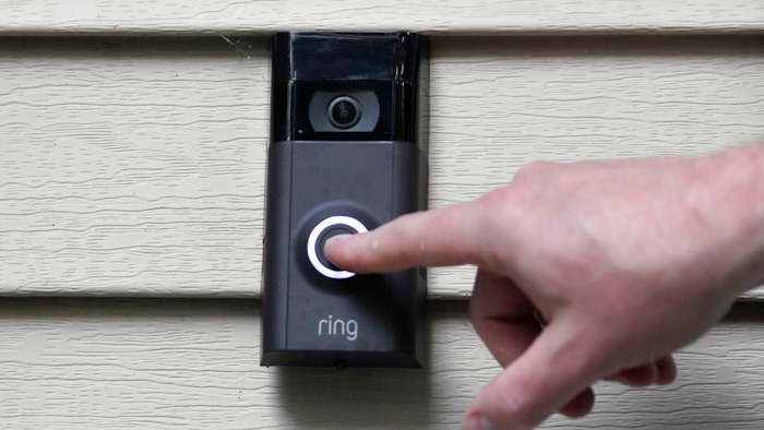 In this July 16, 2019, file photo, Ernie Field pushes the doorbell on his Ring doorbell camera at his home in Wolcott, Conn.